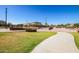 Modern skate park features a smooth concrete path, various ramps, and metal railings in a well-maintained community area at 17235 W Statler St, Surprise, AZ 85388