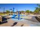 Community splash pad with play structures and seating area at 17235 W Statler St, Surprise, AZ 85388