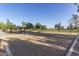 Well-maintained park volleyball court, adjacent to shaded picnic area and open green space at 17235 W Statler St, Surprise, AZ 85388