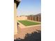 Turf backyard is framed by gravel and paver stones at 17427 W Hadley St, Goodyear, AZ 85338