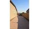 Paver driveway alongside a home with block fencing to define the backyard at 17427 W Hadley St, Goodyear, AZ 85338