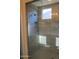 Modern tiled shower with rainfall showerhead and built-in niche at 17427 W Hadley St, Goodyear, AZ 85338