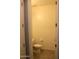 Powder room with neutral paint, toilet, and entry door at 17427 W Hadley St, Goodyear, AZ 85338