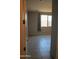 Bedroom with neutral walls, tile flooring, and a window providing natural light at 17427 W Hadley St, Goodyear, AZ 85338