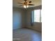 Bright bedroom with tile flooring, neutral walls, and a view to the backyard at 17427 W Hadley St, Goodyear, AZ 85338
