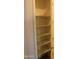 Linen closet with white shelves and neutral paint at 17427 W Hadley St, Goodyear, AZ 85338