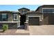 Beautiful single-story home with a brick driveway, stone accents, and a private gated entrance at 17427 W Hadley St, Goodyear, AZ 85338
