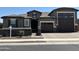 Charming single-Gathering home with a two-car garage and welcoming brick driveway and stone accents at 17427 W Hadley St, Goodyear, AZ 85338