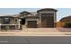 Attractive single-Gathering home with a two-car garage, brick driveway and private gated entry at 17427 W Hadley St, Goodyear, AZ 85338
