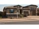 Single story house featuring brick driveway, stone accents, and a private gated entrance at 17427 W Hadley St, Goodyear, AZ 85338