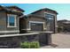 Single story house featuring brick driveway, stone accents, and a private gated entrance at 17427 W Hadley St, Goodyear, AZ 85338
