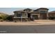 Inviting single-level home with brick driveway, stone accents, and neatly landscaped front yard at 17427 W Hadley St, Goodyear, AZ 85338