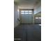 Two-car garage with concrete floors and garage doors with window panels at 17427 W Hadley St, Goodyear, AZ 85338