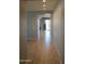 Bright hallway with tiled flooring leading to a room with light pouring in at 17427 W Hadley St, Goodyear, AZ 85338