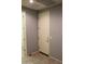 Hallway featuring neutral paint with access to garage and walk-in closet at 17427 W Hadley St, Goodyear, AZ 85338