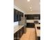 Well-equipped kitchen boasts stainless steel appliances, sleek black cabinets, and ample counter space for cooking at 17427 W Hadley St, Goodyear, AZ 85338