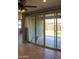 Spacious living room featuring tile floors, recessed lighting, and a glass sliding door at 17427 W Hadley St, Goodyear, AZ 85338