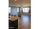 Open floor plan showcases a spacious living room with tiled floors and bright natural light from several windows at 17427 W Hadley St, Goodyear, AZ 85338