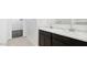 Bright bathroom featuring a marble countertop, dual sinks, and stylish dark-stained cabinetry at 1785 W Solstice Ave, Apache Junction, AZ 85120