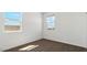 Bedroom with carpeted floor and two windows with neighborhood views at 1785 W Solstice Ave, Apache Junction, AZ 85120