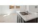 Kitchen island features a double sink and marble countertop at 1785 W Solstice Ave, Apache Junction, AZ 85120
