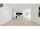 Bright, open-concept room with a kitchen, white walls, tile floors, and modern lighting at 1785 W Solstice Ave, Apache Junction, AZ 85120