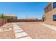Expansive backyard featuring gravel landscaping, block fence, and string lights overhead at 18663 W Vogel Ave, Goodyear, AZ 85338