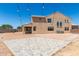 Spacious backyard featuring a large patio area, desert landscaping, and string lights at 18663 W Vogel Ave, Goodyear, AZ 85338