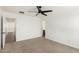 Bright bedroom with a ceiling fan and neutral carpet at 18663 W Vogel Ave, Goodyear, AZ 85338