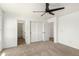 This bedroom features plush carpet, a ceiling fan, closet, and two doorways at 18663 W Vogel Ave, Goodyear, AZ 85338