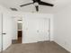 Bedroom features soft carpet, ceiling fan, closet and a doorway to the bathroom at 18663 W Vogel Ave, Goodyear, AZ 85338