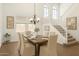 Formal dining room with a chandelier, large windows, and staircase at 18663 W Vogel Ave, Goodyear, AZ 85338