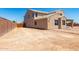 Exterior view of the backyard showing ample space for customization and a wooden gate at 18663 W Vogel Ave, Goodyear, AZ 85338