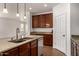Kitchen island with granite countertops, stainless steel sink and appliances, adjacent to living space at 18663 W Vogel Ave, Goodyear, AZ 85338
