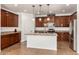 Kitchen with stainless steel appliances, granite counters, an island and ample cabinet storage at 18663 W Vogel Ave, Goodyear, AZ 85338