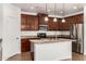 Modern kitchen featuring granite countertops, stainless steel appliances, and pendant lighting at 18663 W Vogel Ave, Goodyear, AZ 85338