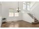 Living area with stairs and high ceilings filled with natural light and chandelier at 18663 W Vogel Ave, Goodyear, AZ 85338