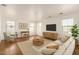 Bright living room featuring a sofa, a TV, a desk, and a large rug at 18663 W Vogel Ave, Goodyear, AZ 85338