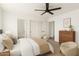 Main bedroom with natural light, ensuite bathroom, and a neutral decor at 18663 W Vogel Ave, Goodyear, AZ 85338