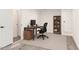 Minimalist office space with gray floors, a wooden desk, and shelving at 18663 W Vogel Ave, Goodyear, AZ 85338