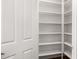 Spacious walk-in pantry with white shelving provides ample storage space at 18663 W Vogel Ave, Goodyear, AZ 85338
