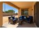 Covered patio featuring comfortable seating, perfect for outdoor relaxation and entertaining at 18663 W Vogel Ave, Goodyear, AZ 85338