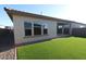 Backyard featuring low maintenance artificial turf, covered patio and stucco wall at 19321 W Luke Ave, Litchfield Park, AZ 85340
