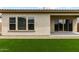 Image showcasing backyard area with grass, rock bed and covered patio area, with ample natural light at 19321 W Luke Ave, Litchfield Park, AZ 85340