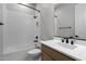 Well-lit bathroom featuring a shower-tub combination, white tile, and a modern vanity with matte black hardware at 19321 W Luke Ave, Litchfield Park, AZ 85340