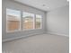Bedroom with neutral carpet and three large windows that provide ample natural light at 19321 W Luke Ave, Litchfield Park, AZ 85340
