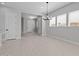 Dining area with tiled floors, modern chandelier, and windows that bring in plenty of natural light at 19321 W Luke Ave, Litchfield Park, AZ 85340