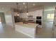 Modern kitchen with white cabinets, stainless steel appliances, and a large center island at 19321 W Luke Ave, Litchfield Park, AZ 85340