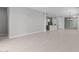 Open-concept living room with light tile flooring that seamlessly connects the living space to the kitchen and dining area at 19321 W Luke Ave, Litchfield Park, AZ 85340
