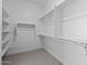 Bright and organized walk-in closet with built-in shelving, providing ample storage space at 19321 W Luke Ave, Litchfield Park, AZ 85340